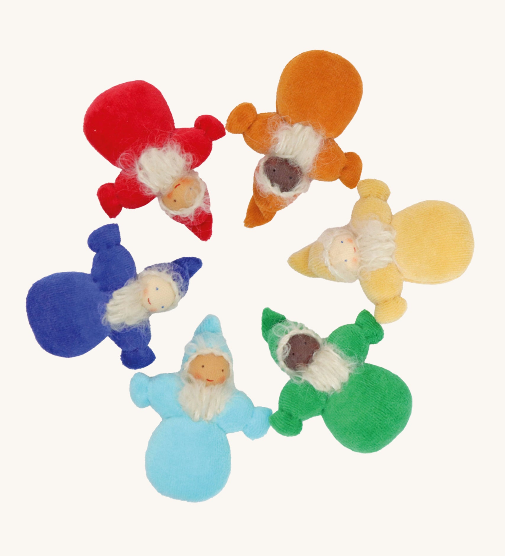 Grimm's Rainbow Dwarfs, placed in a circle. Each doll is one colour of the rainbow and is light blue, dark blue/indigo, red, orange, yellow or green. Each doll has a warm smiling face a long beard and a pointed hat. The image is on a cream background