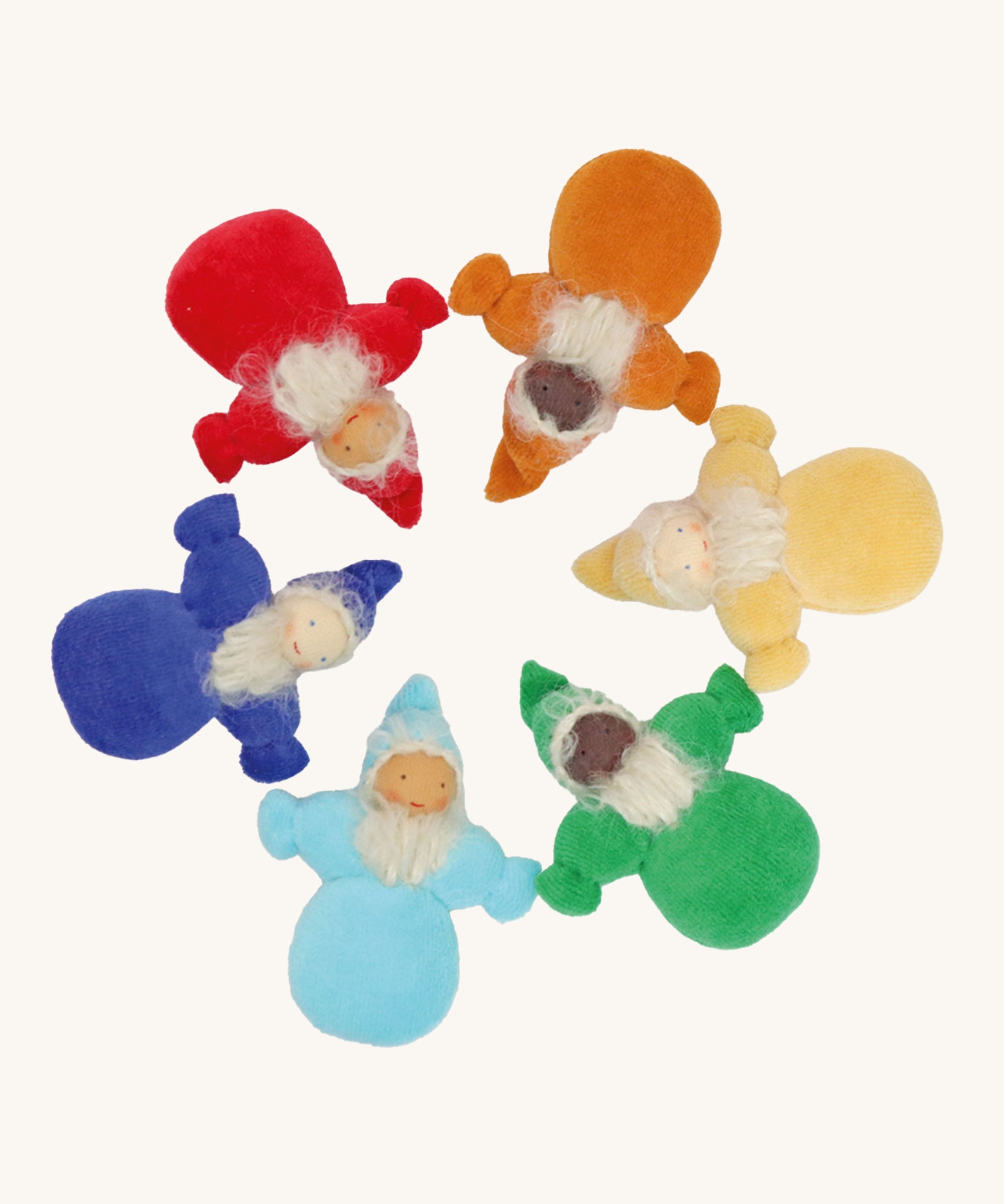 Grimm's Rainbow Dwarfs, placed in a circle. Each doll is one colour of the rainbow and is light blue, dark blue/indigo, red, orange, yellow or green. Each doll has a warm smiling face a long beard and a pointed hat. The image is on a cream background