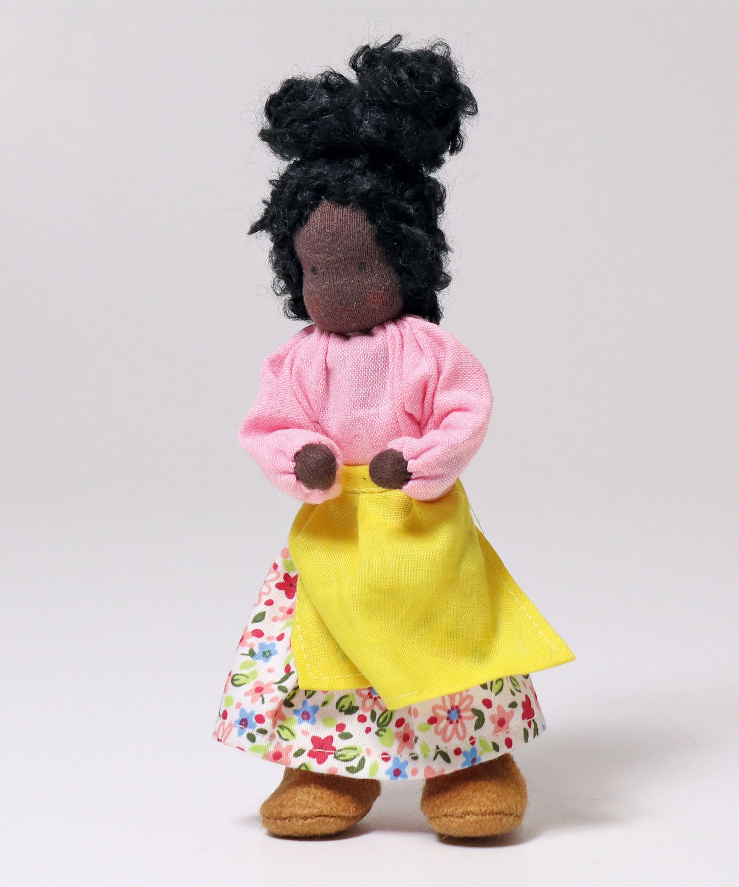 Grimm's Handmade Doll - Mrs Ebony is stood upright with its arm bent at the elbows towards its middle. The image is on a light grey background