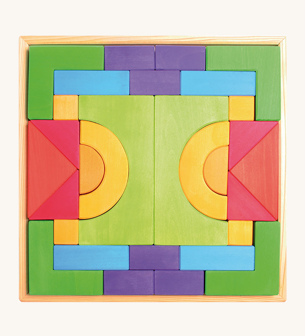 Grimm's Basic Building Set is a set of colourful wooden blocks in different shapes and sizes, in a wooden tray.