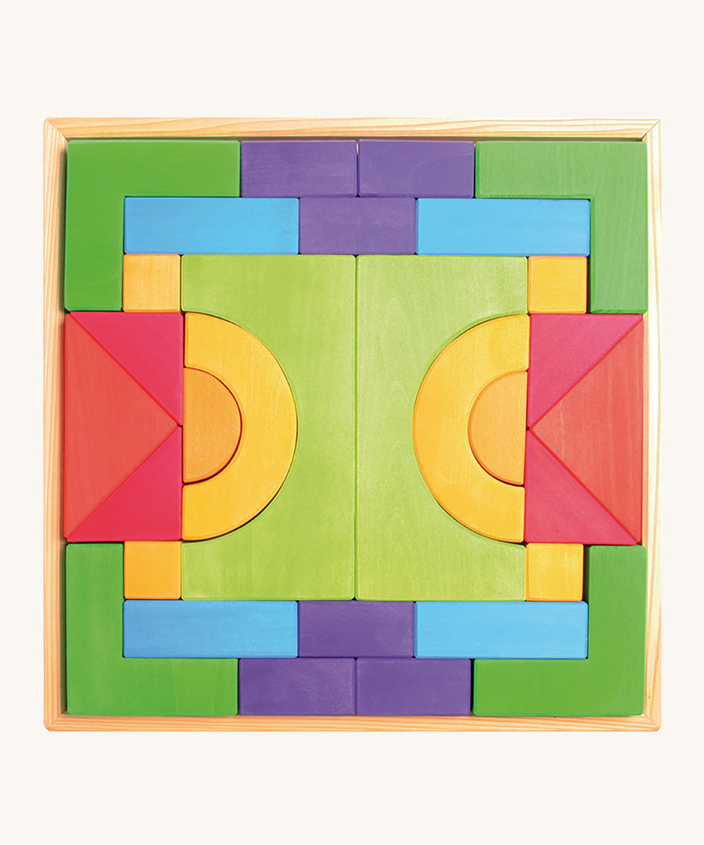 Grimm's Basic Building Set is a set of colourful wooden blocks in different shapes and sizes, in a wooden tray.