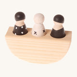 Grimm's 3 in a Boat Monochrome is a fun wooden Waldorf toy which includes three wooden peg dolls in black and white monochrome print sat in side a wooden curved based boat which rocks side to side. The image is on a cream background