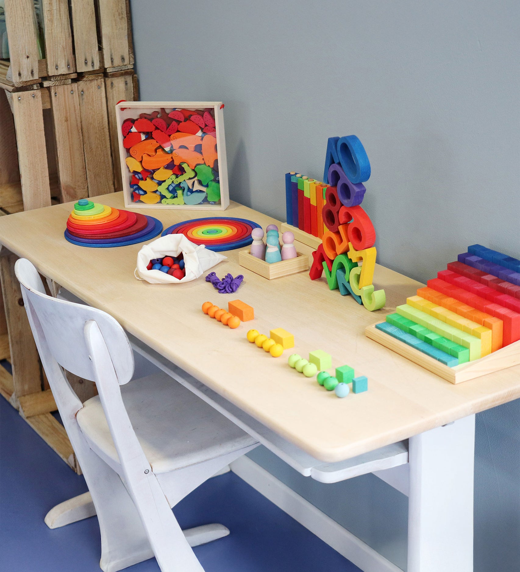 A table full of Grimm's Wooden educational and number toys, ready for learning