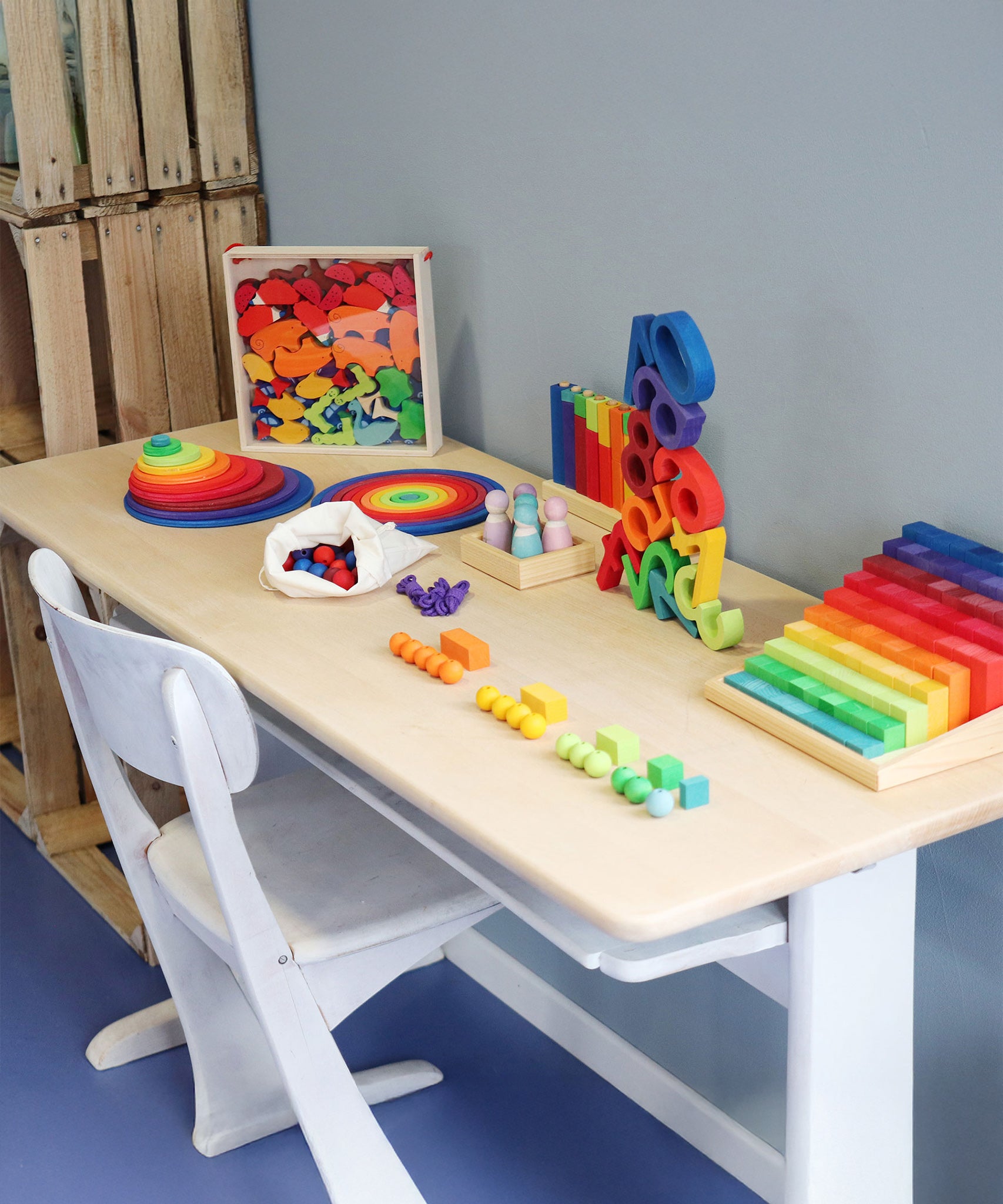 A table full of Grimm's Wooden educational and number toys, ready for learning