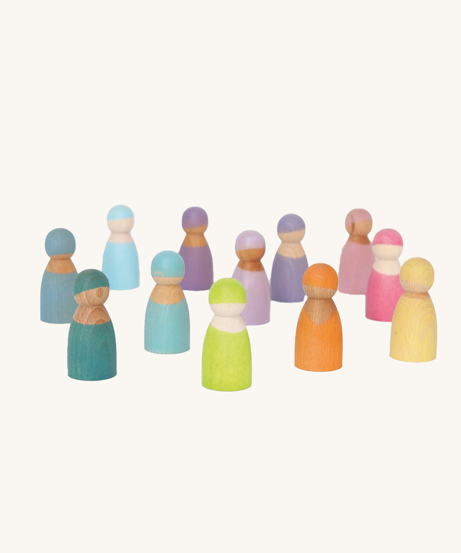 Grimm's 12 Pastel Friends, hand painted wooden peg dolls in hues of blue, pink, purple orange, green and yellow stood on a cream background