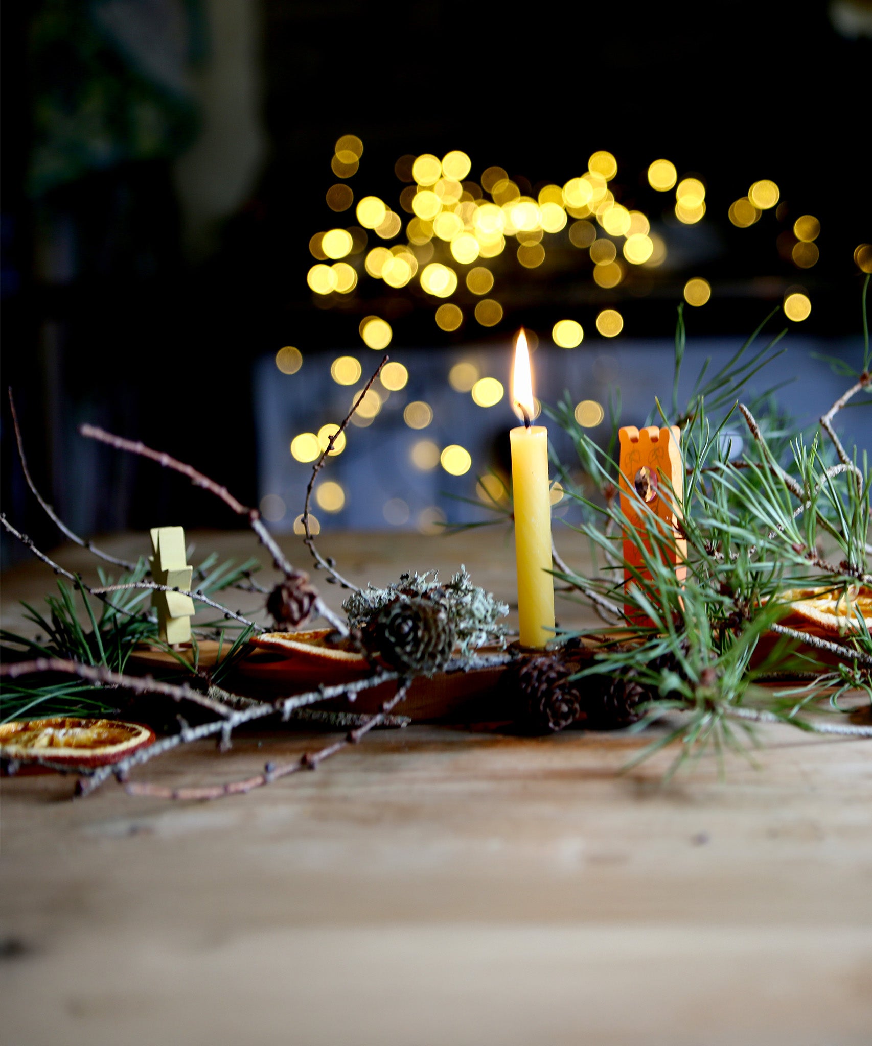 A beautiful winter display using tree leaves, and branches on top of the Grimm's Celebration Ring. There are also Grimm's Decorative figures in the display too.