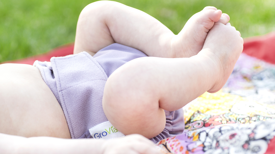 Baby wearing a violet GroVia nappy