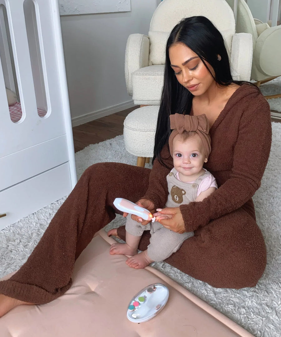 A parent using the Baby Nail Care Set, on their child's finger nails