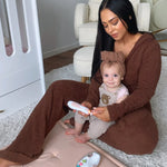 A parent using the Baby Nail Care Set, on their child's finger nails