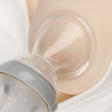 The Haakaa Generation 3 Silicone Breast Pump Shield Attachment, being used to collect breast milk into a Haakaa Baby bottle