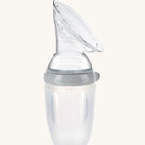 The Haakaa Generation 3 Silicone Breast Pump Shield Attachment, is attached to a Haakaa baby bottle