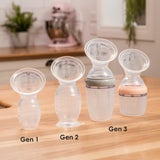 A collection of Haaka Breast Pumps from Generation 1, 2 and 3, each with various attachments