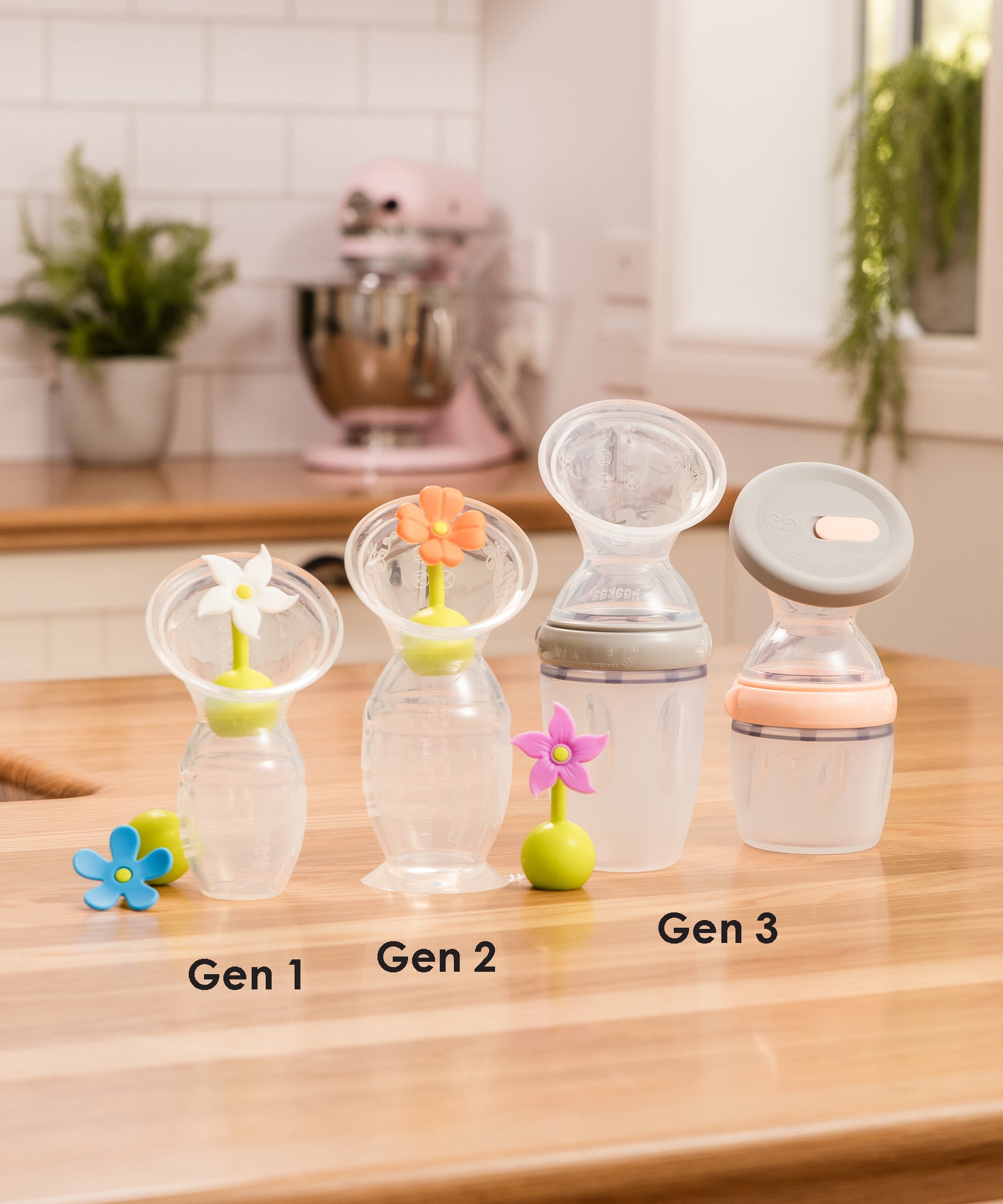 A collection of Haakaa Breast Pumps from Generation 1, 2 and 3, each with various attachments and accessories