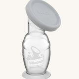 Haakaa Generation 2 Silicone Breast Pump with Suction Base and grey cap on a cream background