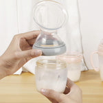 A person attaching the Haakaa Generation 3 Silicone Breast Pump Flange Attachment to a Haakaa baby Bottle