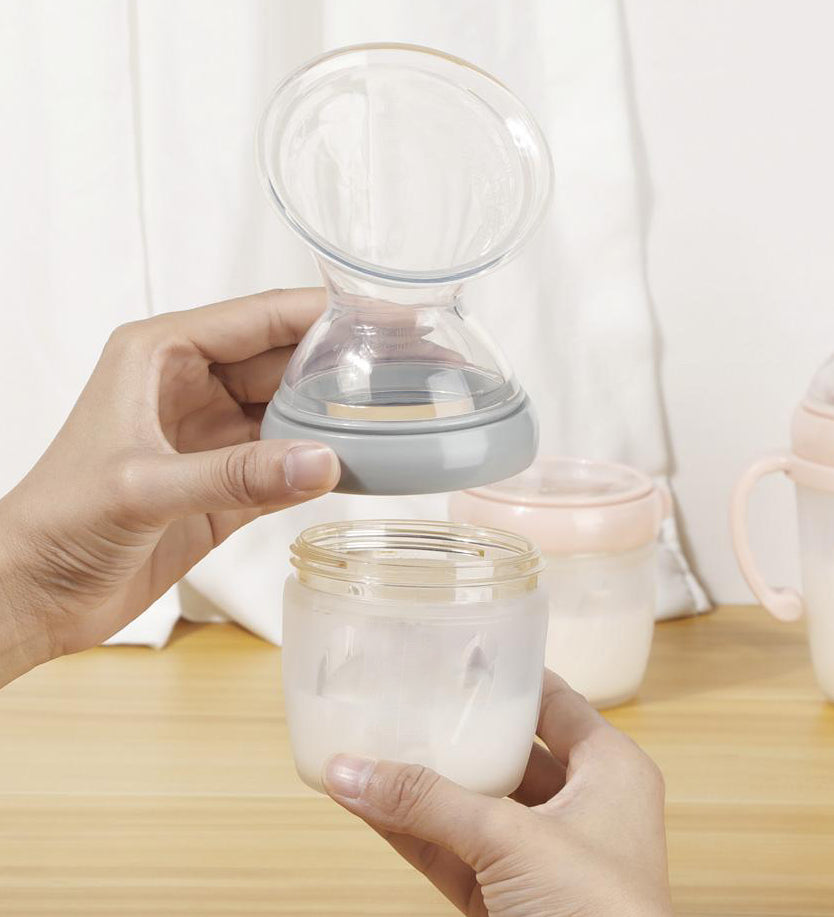 A person attaching the Haakaa Generation 3 Silicone Breast Pump Flange Attachment to a Haakaa baby Bottle