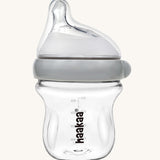 The Haakaa Generation 3 Glass Baby Bottle 120ml, in grey on a cream background