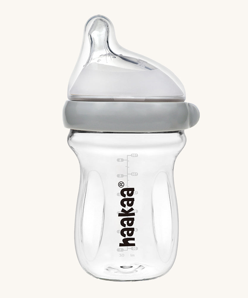 The Haakaa Generation 3 Glass Baby Bottle 180ml in grey on a cream background 