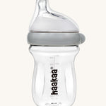 The Haakaa Generation 3 Glass Baby Bottle 180ml in grey on a cream background 