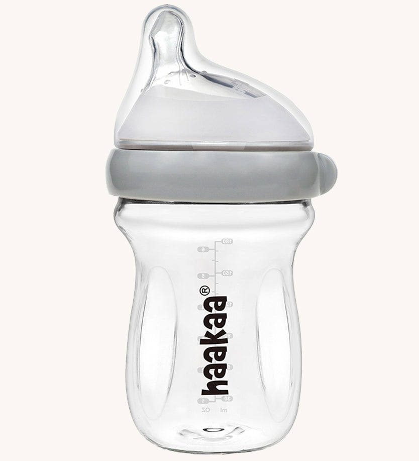 The Haakaa Generation 3 Glass Baby Bottle 180ml in grey on a cream background 