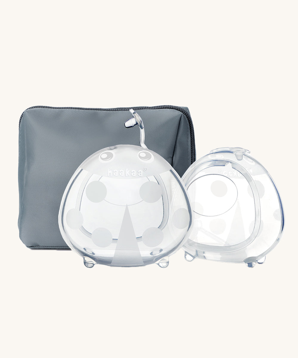 The Haakaa Ladybug Silicone Breast Milk Collector and storage bag in Bluestone, which is a slate grey/blue colour. On a cream background