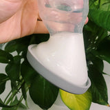 A person turning the Generation 1 100ml Silicone Breast Pump & Silicone Cap upside down to show it is leakproof