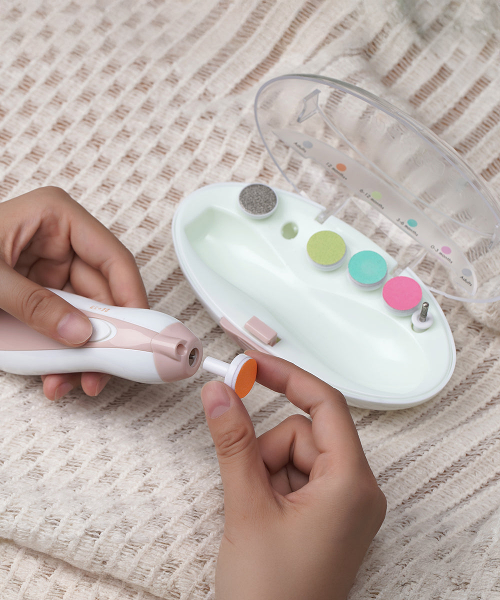 A person attaching a filing pad to the Baby Nail Care Set