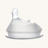 Haakaa Orthodontic Baby Bottle Nipple made from silicone with a thumb-shaped offset teat. Cream background.