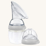 The Generation 3 160ml Breast Pump and Baby Bottle Top in grey. on a cream background. This set come with the Haakaa Gen. 3 Silicone Breast Pump and Baby Bottle Top.