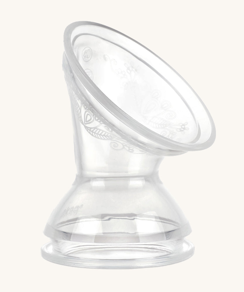 The Haakaa Generation 3 Silicone Breast Pump Flange/ Breast Pump Shield Attachment on a cream background