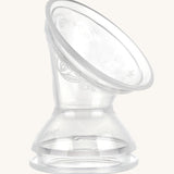 The Haakaa Generation 3 Silicone Breast Pump Flange/ Breast Pump Shield Attachment on a cream background