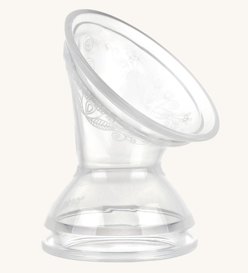 The Haakaa Generation 3 Silicone Breast Pump Flange/ Breast Pump Shield Attachment on a cream background