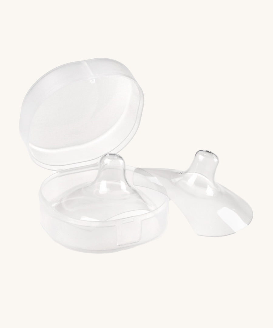 The Haakaa Silicone Nipple Shields, with one shield inside the container box, and one to the right side