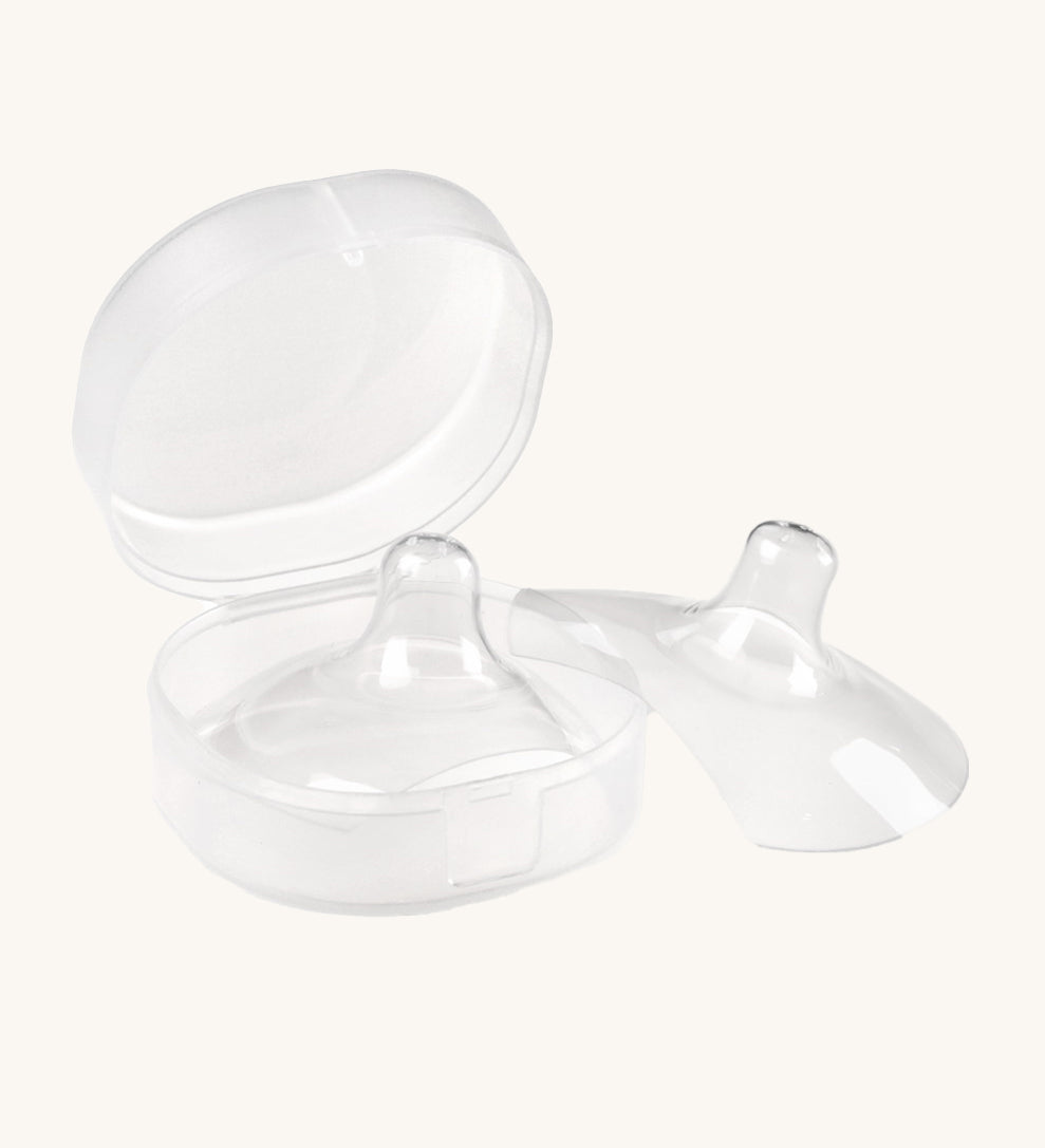 The Haakaa Silicone Nipple Shields, with one shield inside the container box, and one to the right side