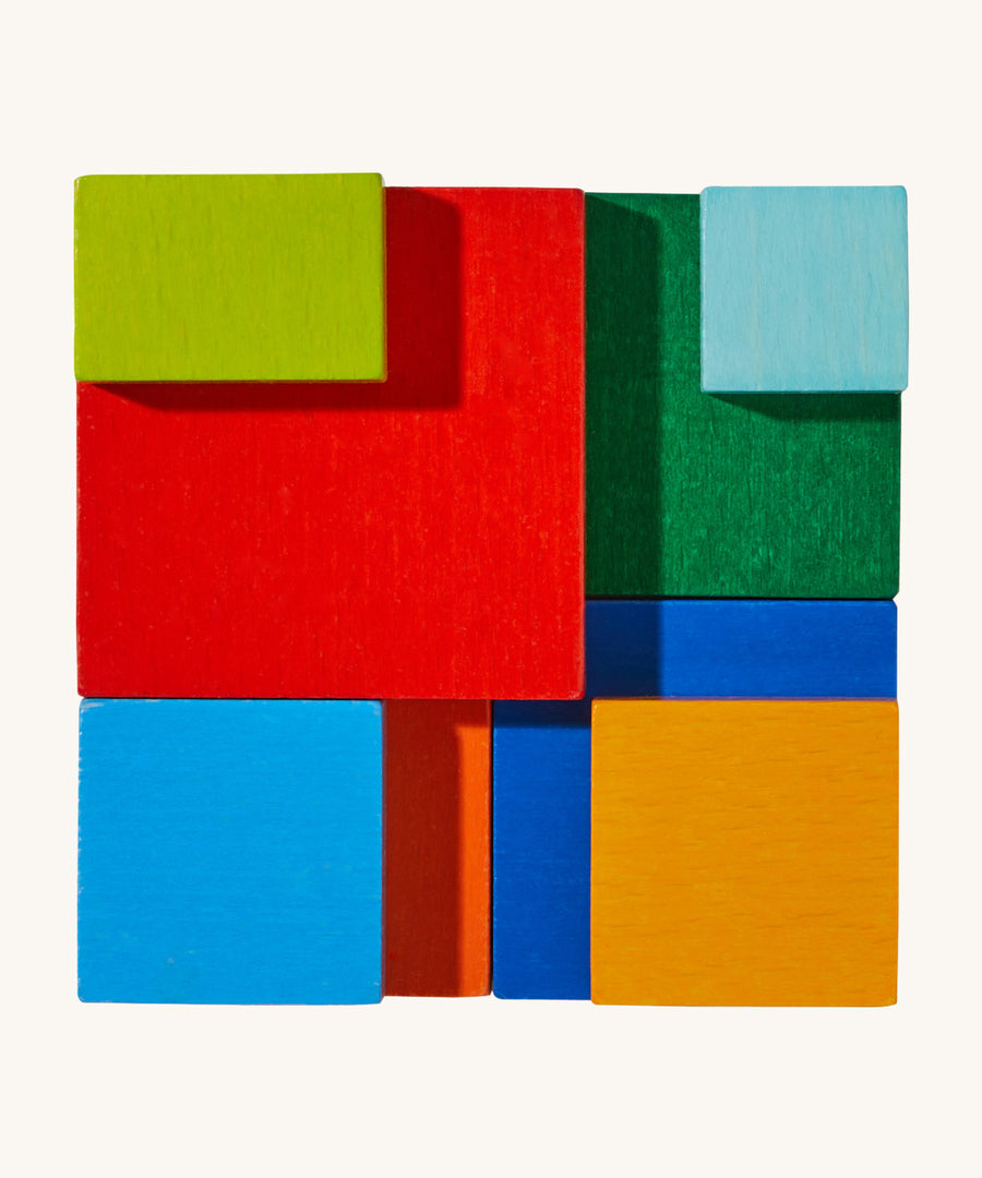 A top view of the wooden 3D  Haba rainbow cube arranging puzzle on a cream background.