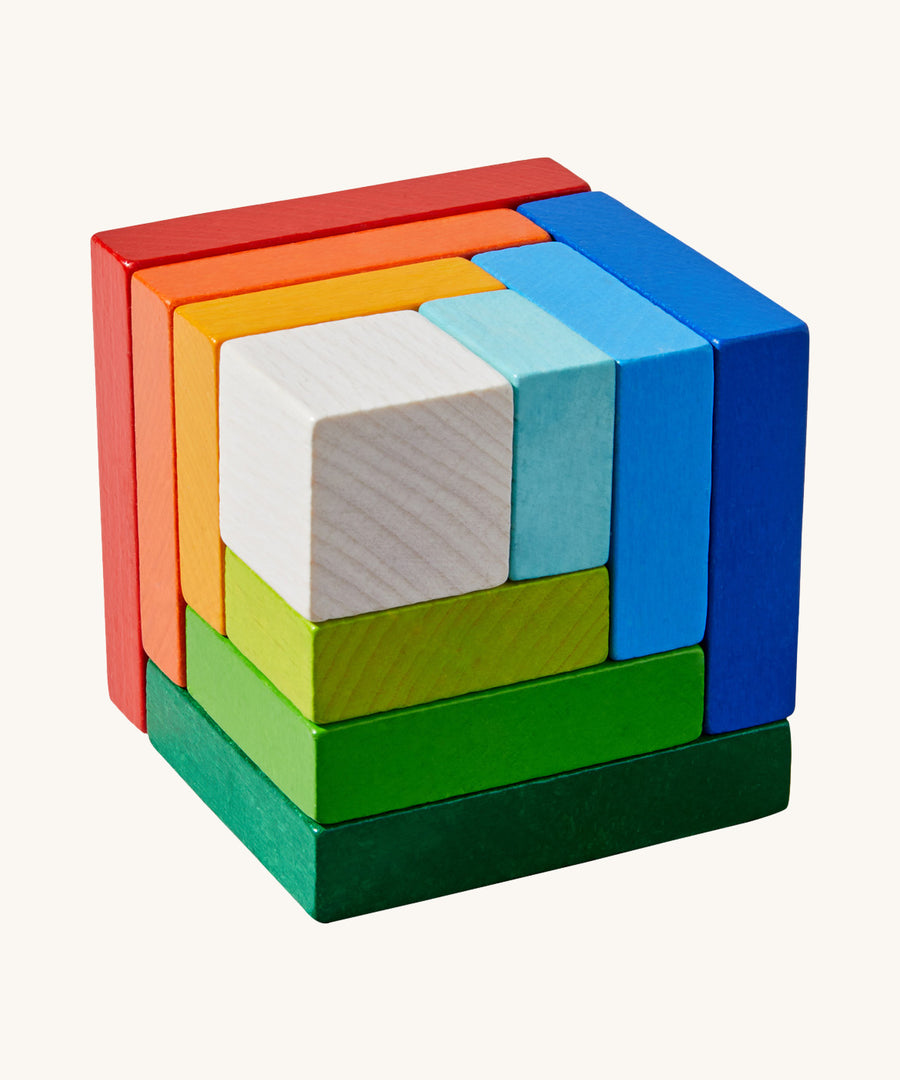 A wooden 3D Haba rainbow cube arranging puzzle on a cream background.