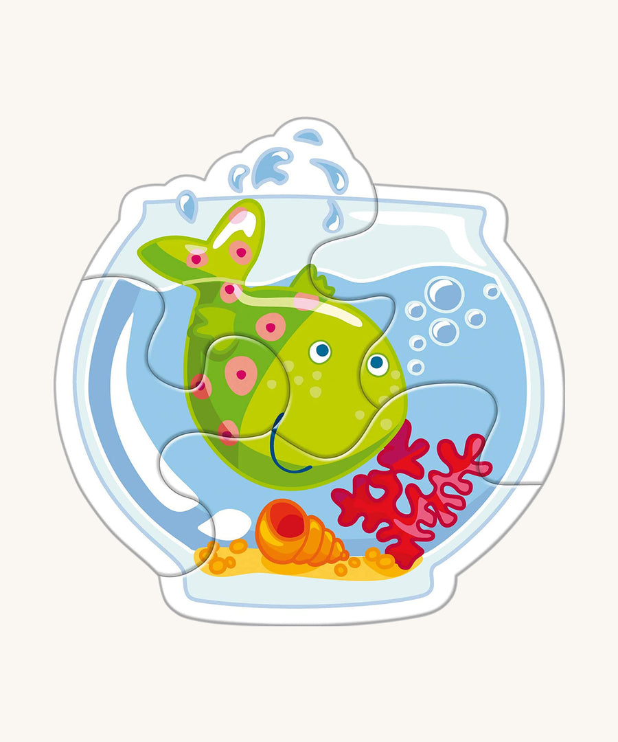 A green fish in a bowl from the Haba animal puzzle set on a cream background