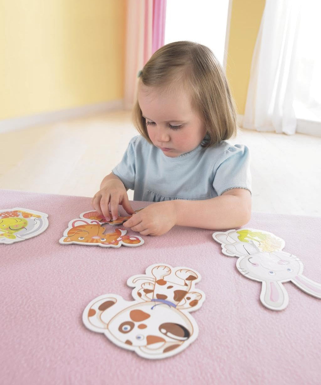 A child playing with the Haba 6 animal puzzle set