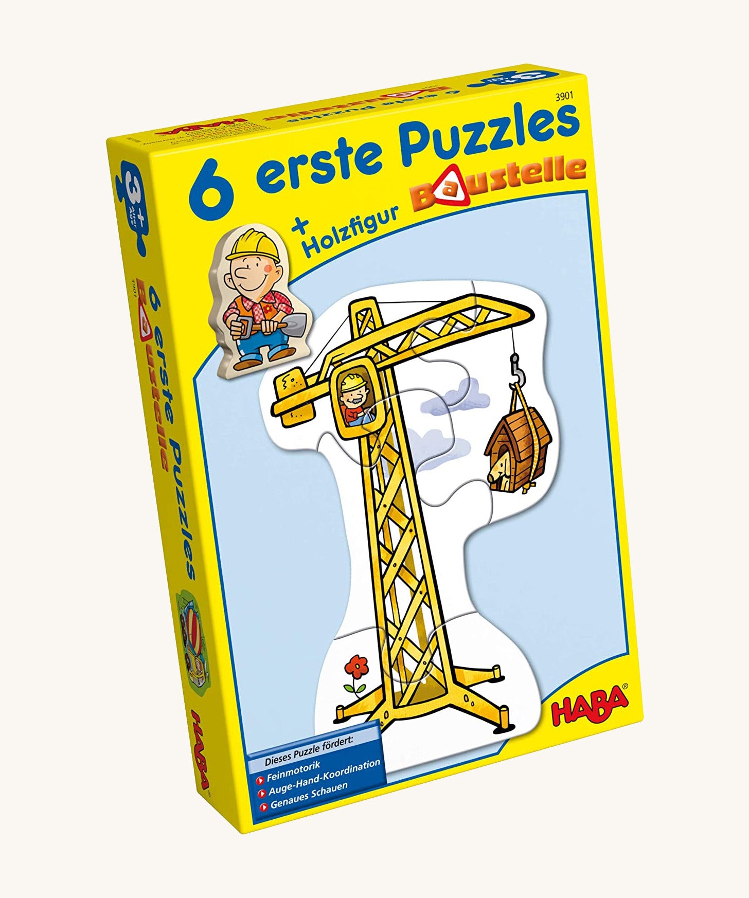 A yellow cardboard box with a picture of a crane on the front for the Haba 6 construction jigsaw puzzle sets on a cream background