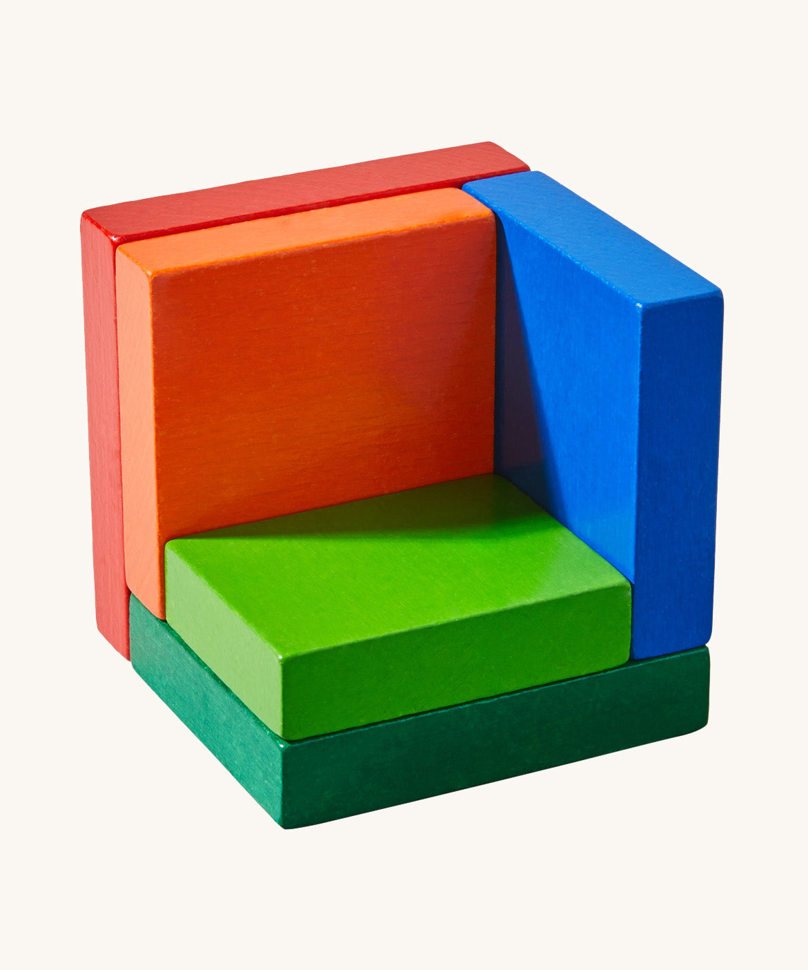 A wooden 3D Haba rainbow cube puzzle on a cream background.