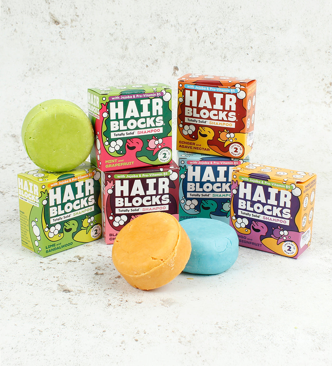 Hair Blocks Solid Shampoo Bars with their cardboard boxes