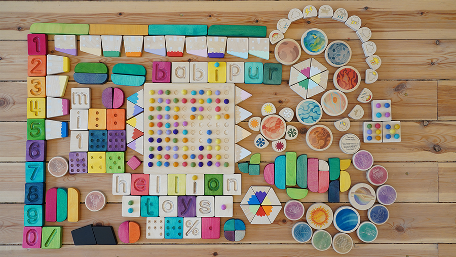 A flatlay of Hellion wooden toys, showing the range f toys from wooden letters and number to 'temperature blobs'