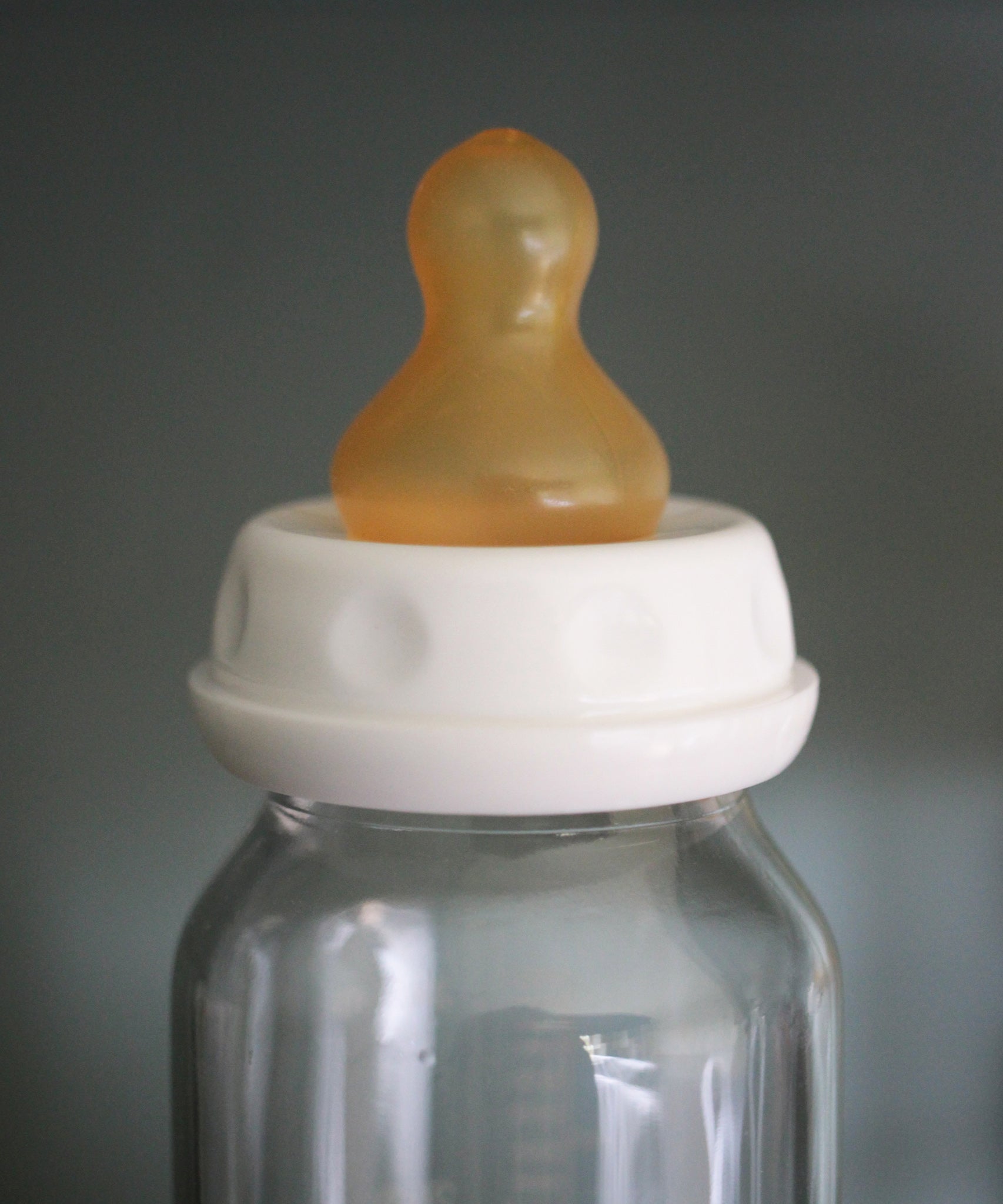 Hevea natural rubber teat on a glass baby bottle. 