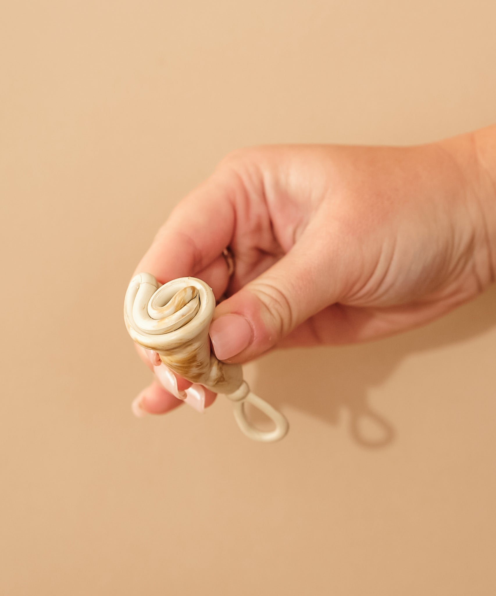 Person demonstrating how to fold a HEVEA LOOP menstrual cup.