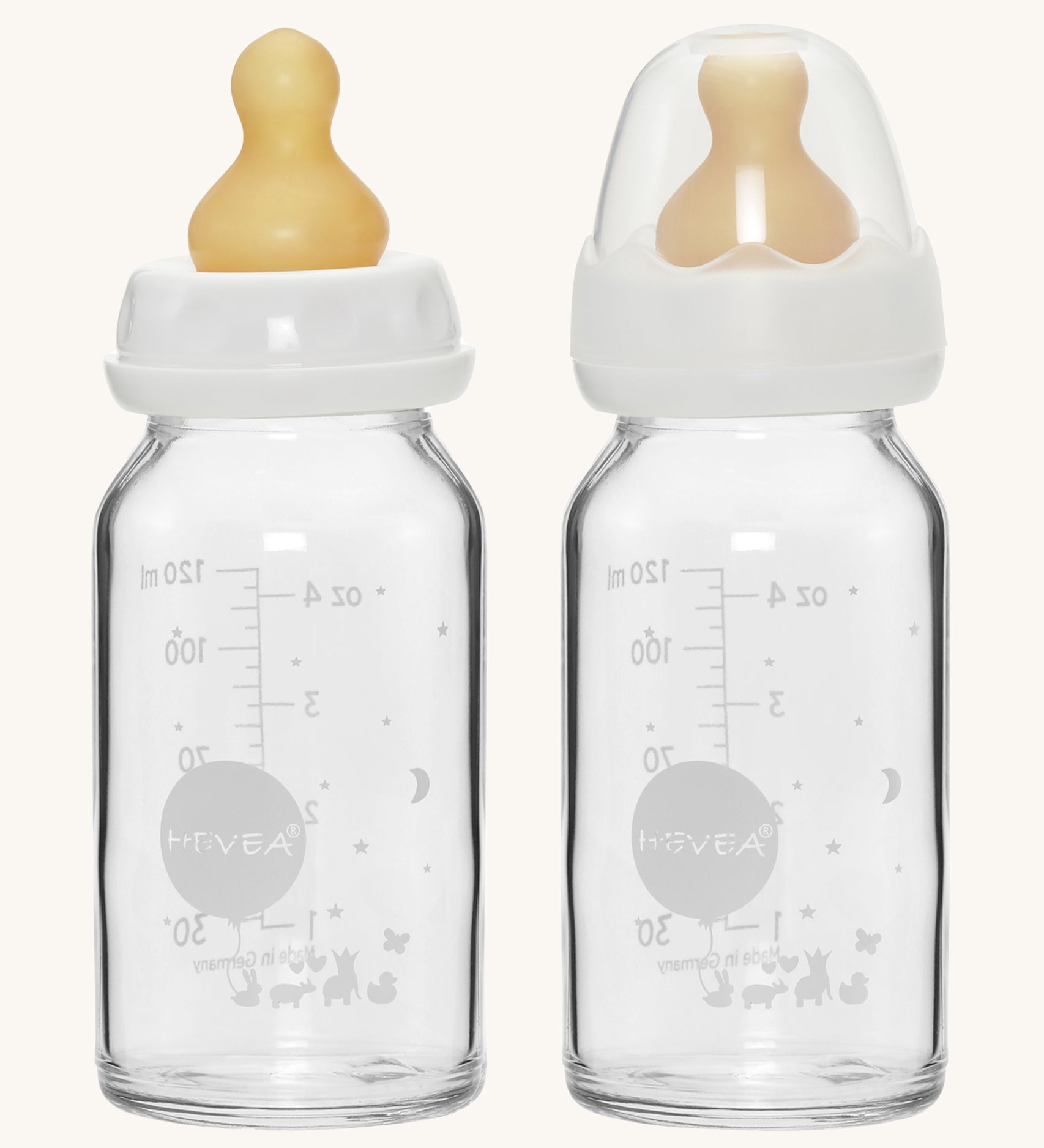 A pack of two Hevea glass baby bottles 120ml with natural rubber teats, one with the dust cap, one without. 