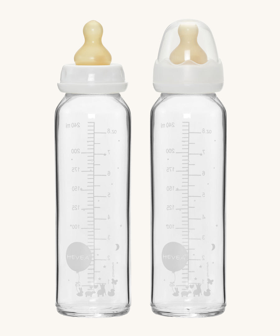 Hevea Glass Baby Bottles Standard Neck 2 Pack - 240ml, one with a dust cap, the other without. 