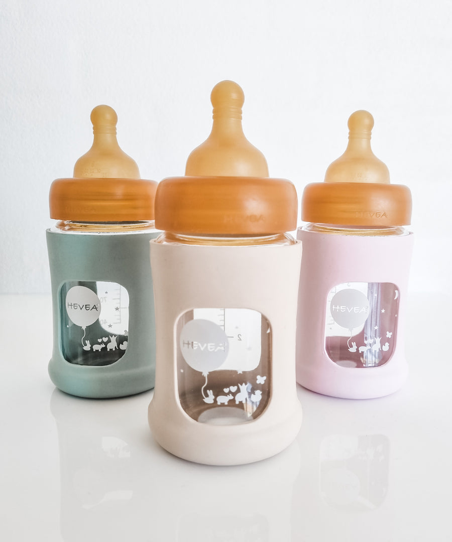 Hevea Glass Baby Bottle Wide Neck With Rubber Sleeve - 150ml in Seafoam Blue, Sand and Powder Pink