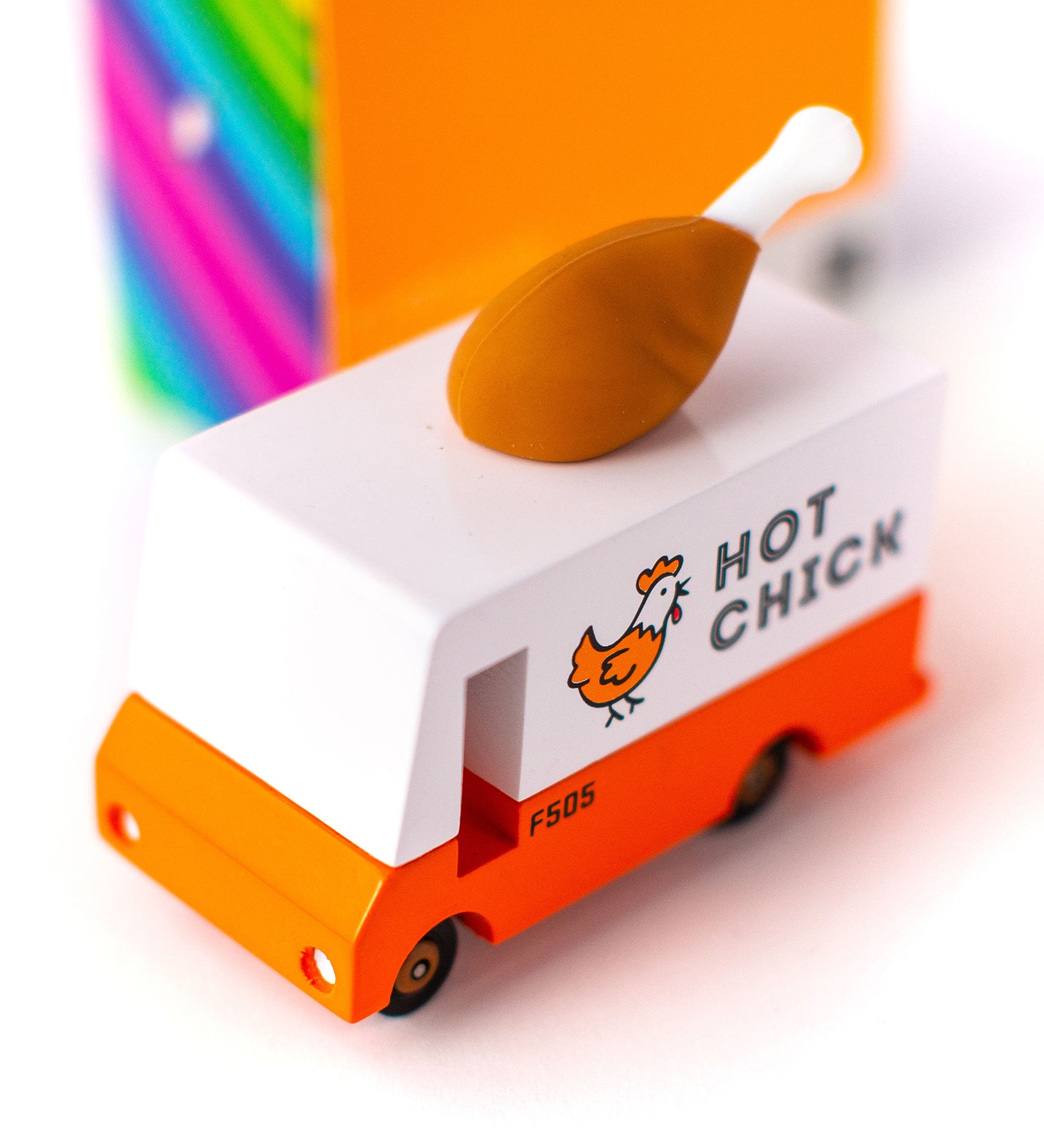 The Candylab Candyvan - Fried Chicken Van, being shown from the top. The images shows a painted chicken on the side of the van with the words "Hot Chick". The rubber chicken drumstick sits on top of the van