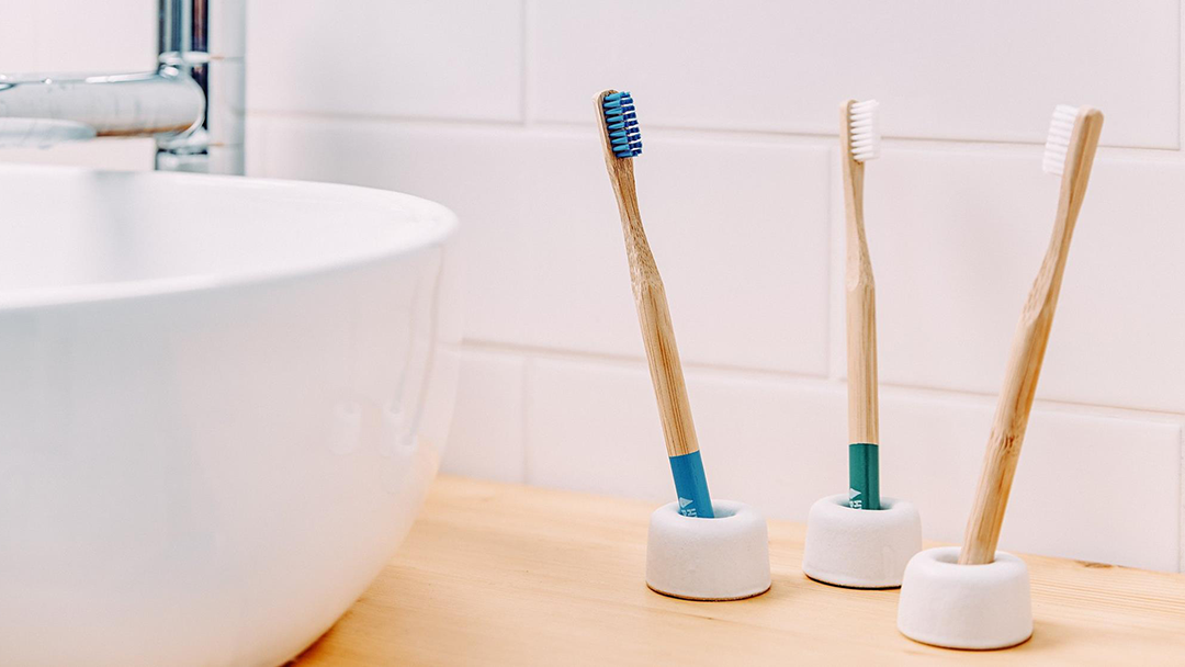 Three Hydrophil eco-friendly bamboo toothbrushes in Hydrophil toothbrush stands