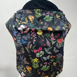 Integra Size 3 baby carrier, Flower Garden. Flower Garden is a beautifully illustrated floral design in soft organic cotton featuring colourful garden flowers and butterflies on a black background.